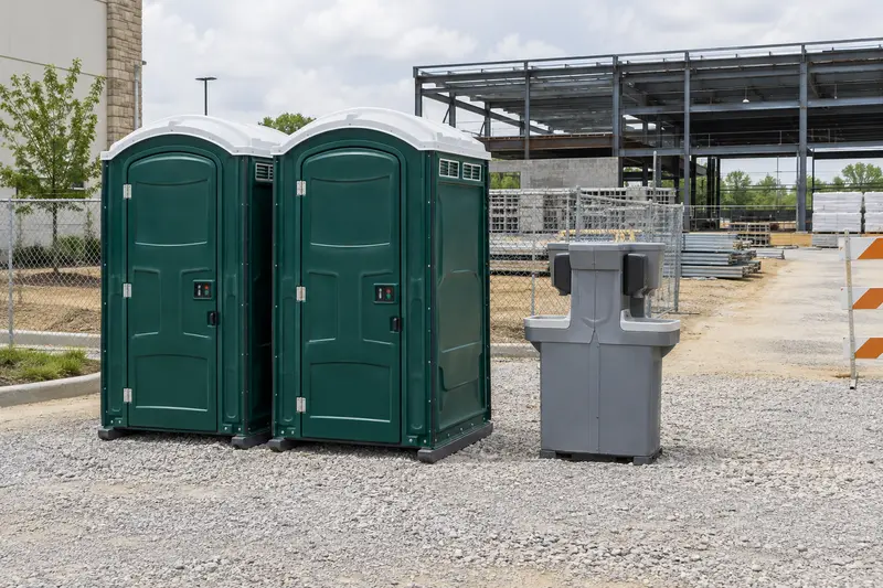 Portable restrooms beside a building project